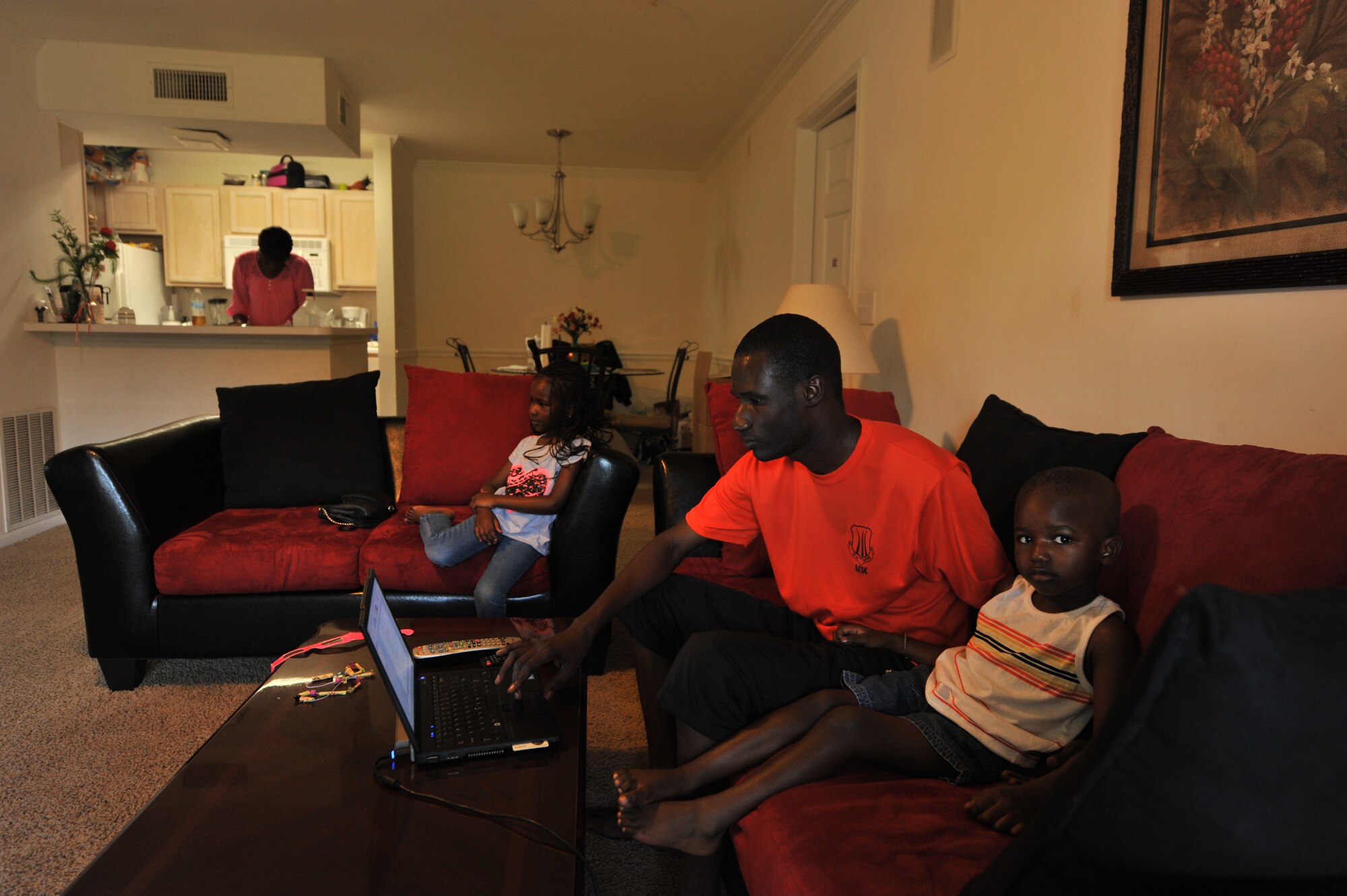 Senegal air force Maj. Papa Dieumb Gueye studies on a Sunday afternoon as his family relaxes. Gueye attends Air Command and Staff College at the Air University where he completes approximately four hours of homework a day. His family is active in the Maxwell Air Force Base community, with his children attending the child development center. His wife meets with other international officer’s spouses that she met through base programs. (U.S. Air Force photo/Staff Sgt. Natasha Stannard)