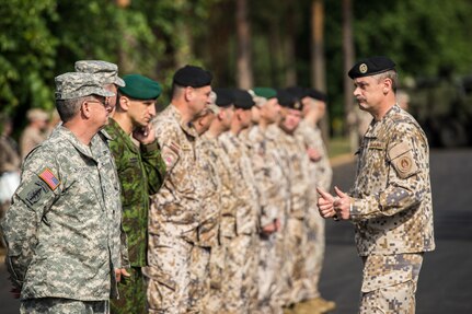 Brig. Gen. Ainars Ozolins, co-director of the Saber Strike Exercise, gives a thumbs up to Maj. Gen. Mark McQueen, the other co-director, during the opening ceremony. The Ceremony took place at Adazi Training Area in Latvia on June 9, 2014. Saber Strike is a multilateral, multifaceted exercise designed to enhance joint and combined interoperability with the U.S. and allied partners. 