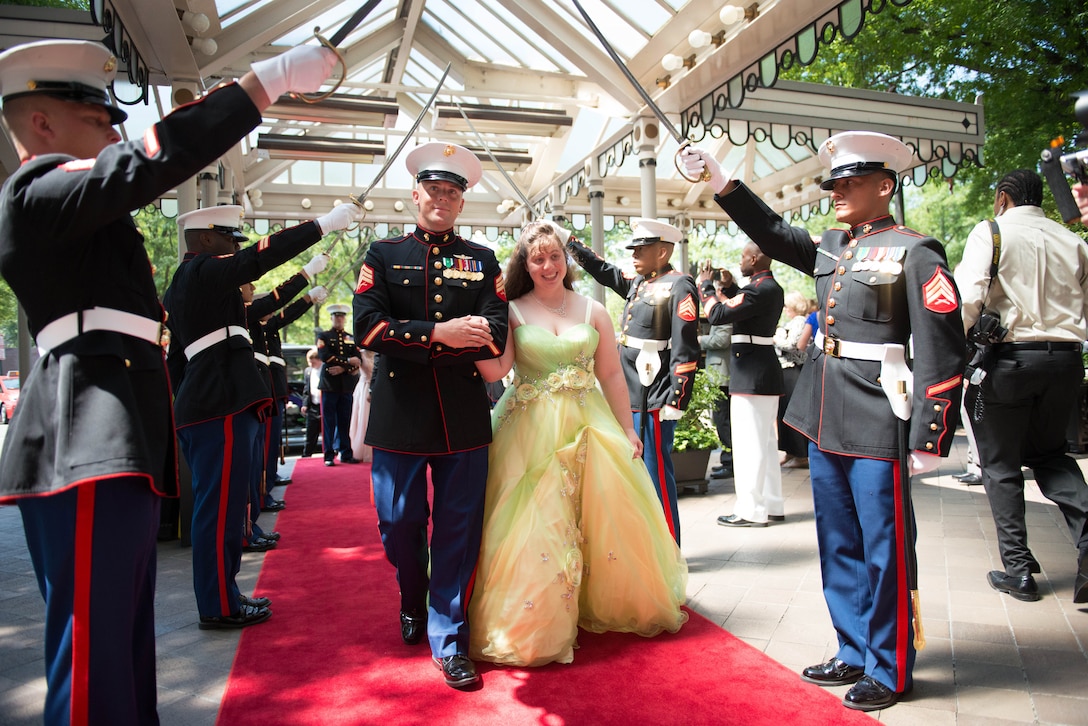 Marines from Marine Corps Base Quantico, Virginia welcomed and escorted each student down the red carpet and through the arch of Marine Corps noncommissioned officer swords at the 9th Annual National Capital Area A Cinderella Ball here, June 8, 2014. The Marines have played a part in A Cinderella Ball since it’s inauguration in 2006. 