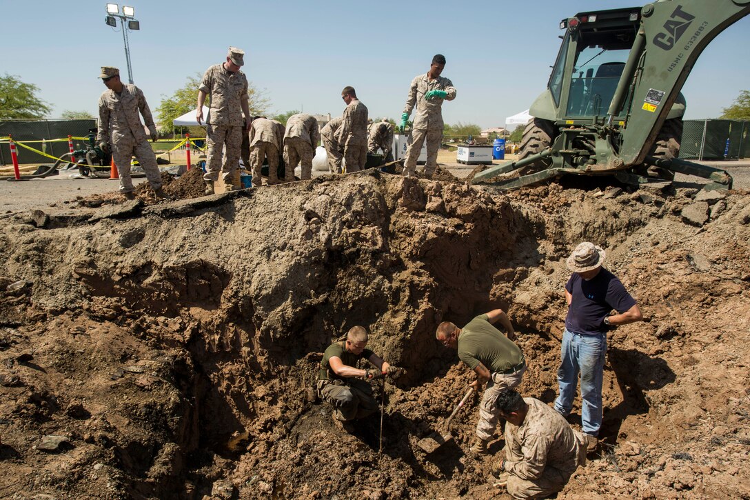 Marines from Marine Wing Support Squadron 371 and other elements of 3rd Marine Aircraft Wing from Marine Corps Air Station Yuma, Ariz., continue their efforts sifting through the debris from the AV-8B Harrier II crash site during the cleanup process in Imperial, Calif., Monday. "We are finishing the reclamation of the aircraft to recover all the small pieces, sifting through the dirt by hand," said Lt. Col. John Ferguson, the executive officer of Marine Aircraft Group 13, stationed at MCAS Yuma.  "We are working on getting the contamination out and then turning it over to the contractors to finish cleanup with the hazardous materials after the major components have all been recovered."