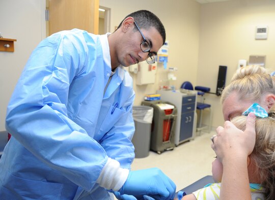 Airman 1st Class Christopher Malone swabs a patient’s arm with alcohol as he prepares to draw her blood May 7, 2014 at the 56th Medical Group laboratory at Luke Air Force Base, Ariz. Malone writes and performs spoken-word poetry, a modern form of poetry that is spoken using theatrical expression. Malone is a 56th Medical Support Squadron medical laboratory apprentice. (U.S. Air Force photo/Staff Sgt. Luther Mitchell Jr.)