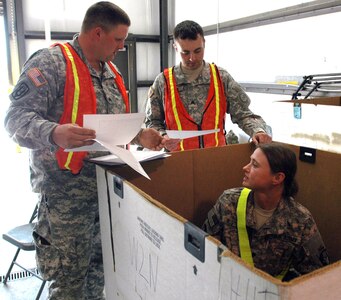 Members of the New York Army National Guard's B Battery 27th Brigade Support Troops Battalion, compare stock numbers with the non-rolling stock in a container March 18, 2012. This training was part of the Redistribution Property Assistance Team Academy that brought to Camp Shelby Joint Forces Training Center. The 27th BTSB is the first unit to receive this training prior to deployment.