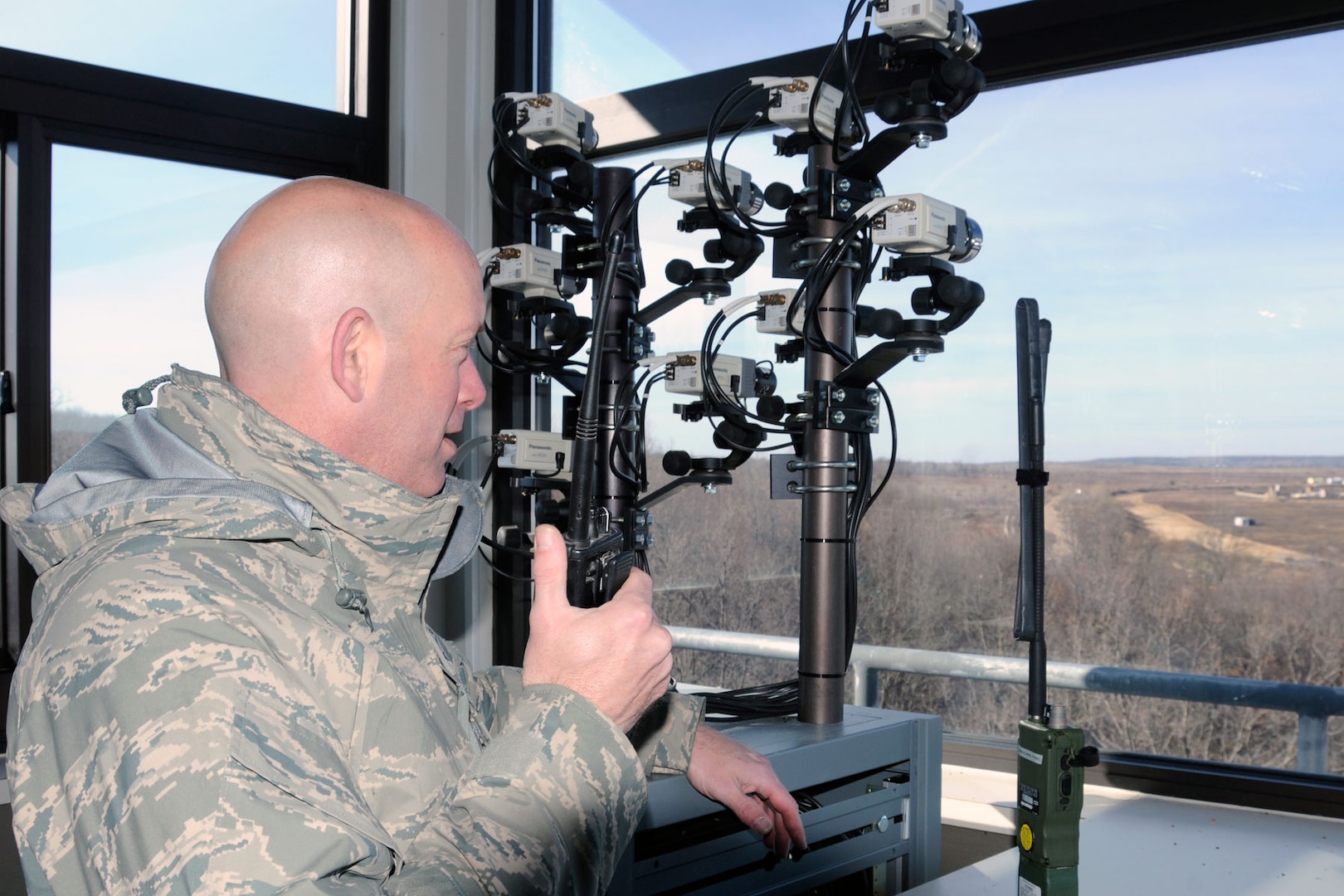 Air National Guard Senior Master Sgt. Alan VanPate communicates with an aircraft while in a control tower at the Grayling Aerial Gunnery Range, near Grayling, Mich., April 24, 2012. VanPate is a joint terminal attack controller and helps to provide training to visiting Joint Terminal Attack Controllers personnel to the Grayling range. JTACs are Air Force enlisted members who embed with infantry or other U.S. Army or Marine Corps ground forces to provide coordination of air power support with the Soldiers or Marines on the ground.