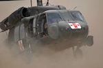 A UH-60 Black Hawk MEDEVAC helicopter with C Company, 1st Battalion, 169th Aviation Regiment, New Mexico National Guard, currently attached to the 25th Combat Aviation Brigade, performs a dust landing during a training flight on Camp Dwyer, Afghanistan, April 4, 2012.