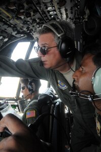 Air Force Master Sgt. Mark Crane (center), a flight engineer with the Kentucky Air National Guard's 123rd Airlift Wing, and Bangladesh air force Sgt. Mohammad Moniruzzaman (right), also a flight engineer, monitor C-130H Hercules aircraft conditions during a flight in support of exercise Cope South at Kurmitola Air Base, Bangladesh, April 25, 2012. Flight engineers monitor aircraft engine systems, determine the performance of the aircraft and manage checklists during each flight. Cope South 12 is a bilateral tactical airlift exercise conducted between the U.S. and Bangladesh air forces that ended April 26. 