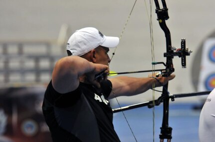 Retired Maryland Army National Guard Staff Sgt. Jesse White takes aim during the 2012 Warrior Games Archery Competition at the Air Force Academy in Colorado Springs, Colo. May 4, 2012. White said following the steps to hit a target in archery helped him to recover from mild traumatic brain injury.