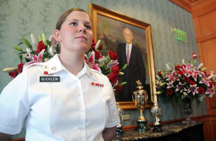 Pfc. Kara Denise Bucklew, a military police officer with the Kentucky Army National Guard's 223rd Military Police Company, guards the winner's trophy in the Director's Room on Millionaire Row at Churchill Downs in Louisville, Ky., during the 138th running of the Kentucky Derby, May 5, 2012.