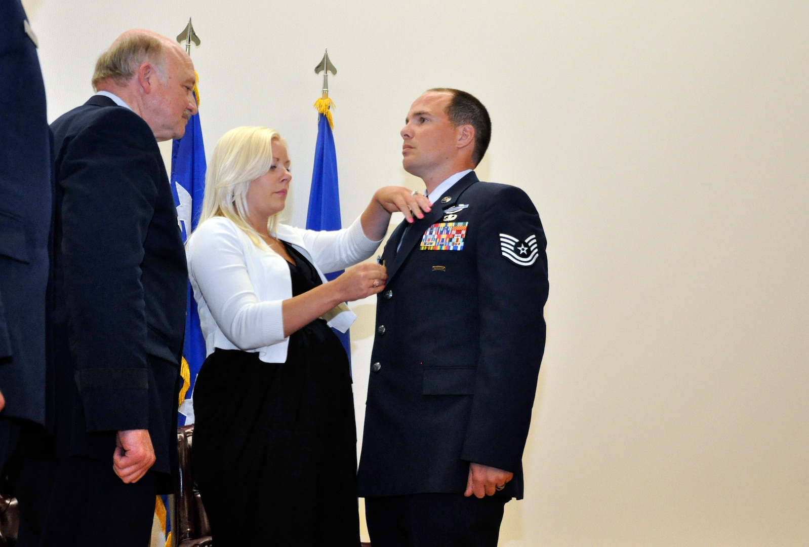 Tech. Sgt. Tavis J. Delaney, with the Washington Air National Guard's 116th Air Support Operations Squadron, stands at attention as his wife Courtney pins the Silver Star medal to his uniform during a presentation ceremony at Joint Base Lewis-McChord, Wash,, May 6, 2012. Delaney received the award—the nation's third highest award for valor in action—for actions in combat during his 2011 deployment to Afghanistan with the squadron.