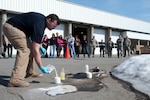 Army 1st Lt. Allen Hulse, science officer with the 103rd Civil Support Team mixes chemicals during a demonstration to chemistry students from Grace Christian School in Anchorage, Alaska. Members of the 103ed CST met with the students as a way to show hands-on and real-world applications for what they are learning in the classroom.