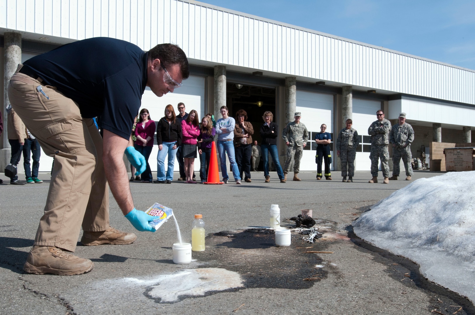 Army 1st Lt. Allen Hulse, science officer with the 103rd Civil Support Team mixes chemicals during a demonstration to chemistry students from Grace Christian School in Anchorage, Alaska. Members of the 103ed CST met with the students as a way to show hands-on and real-world applications for what they are learning in the classroom.