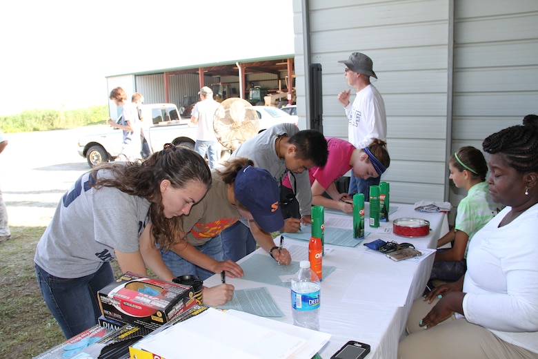 Volunteers sign in before participating in this year’s Norfolk District-sponsored Clean the Bay event.  Approximately 69 volunteers participated in this year’s event at the Craney Island Dredged Material Management Area here June 7, 2014. More than 1,410 pounds of bagged trash and 540 pounds of bulk items were collected.