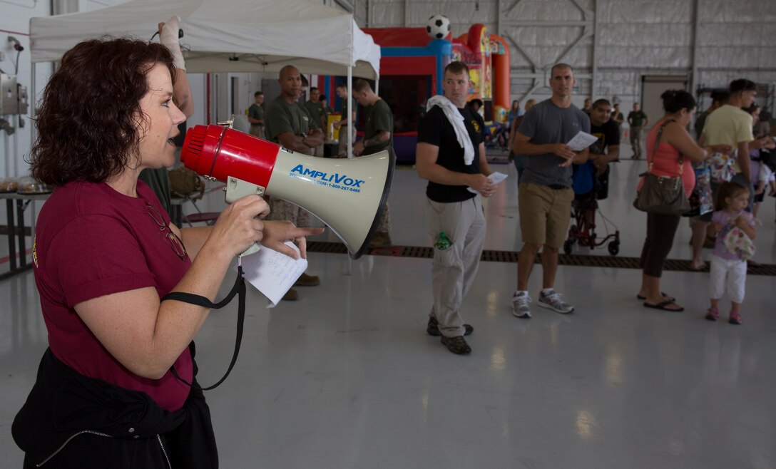 Kelli Richardson, the Marine Aircraft Group 16 family readiness officer, explains the sequence of events to participants, parents and Marines during the MAG-16 Junior Jarhead Day in aboard Marine Corps Air Station Miramar, Calif., June 7. During the event, children were split into platoons by age. Then platoons went through an obstacle course, listened to demonstrations from Aircraft Rescue and Fire Fighting, and ventured through a CH-53E Super Stallion and an MV-22B Osprey.