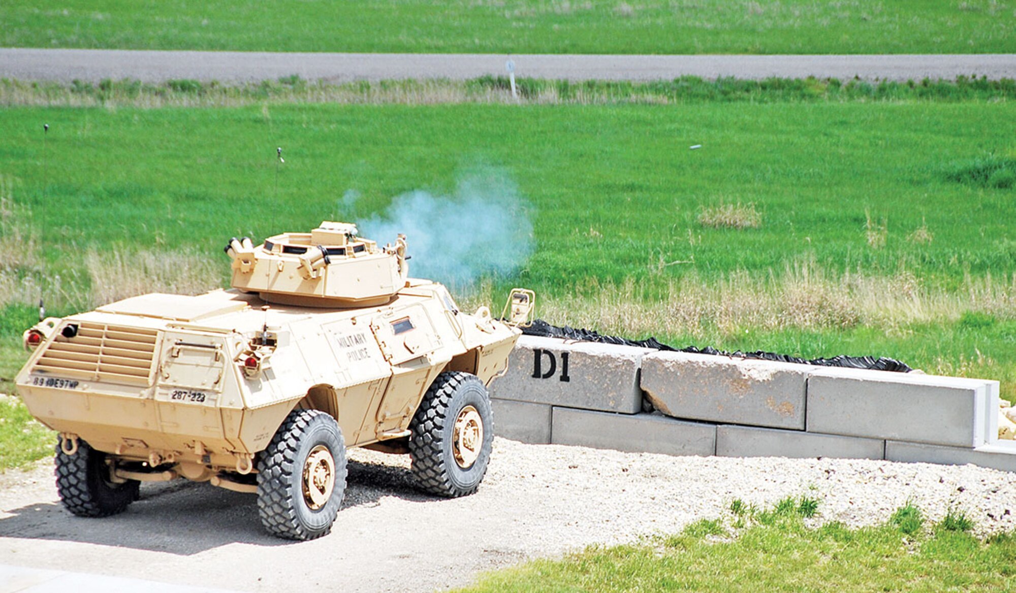 A round leaves a 40 mm grenade launcher during an ASV qualification portion of gunnery training for the 287th MP Co. May 28 at Douthit Gunnery Complex. As targets pop up for each firing table, teams only have 30 to 60 seconds to acquire each target and destroy it. 