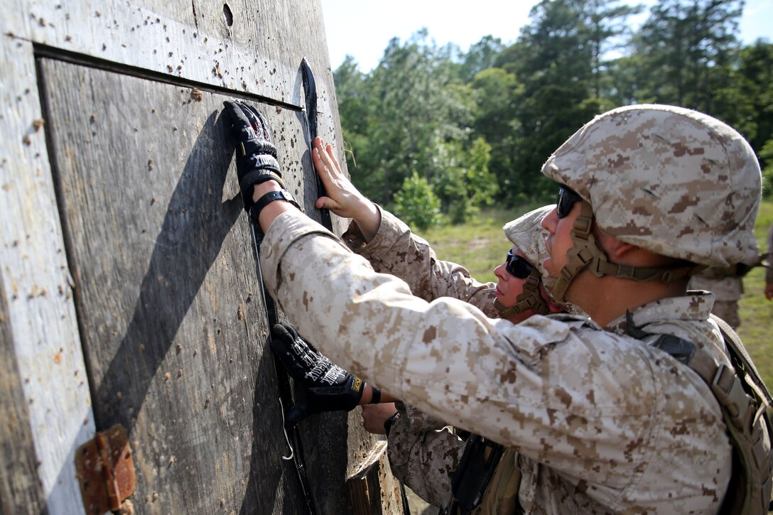 FORT POLK, La. – Assaultmen with 1st Battalion, 23rd Marine Regiment, place explosive charges onto a door frame during a demolition range here, June 3. Marines took part in numerous live-fire ranges, which culminated in a platoon-sized attack as a part of the unit’s annual training. The battalion’s assualtmen were responsible for breaching mock enemy obstacles and clearing the way for follow-on forces.  (Photo by Cpl. John M. McCall)