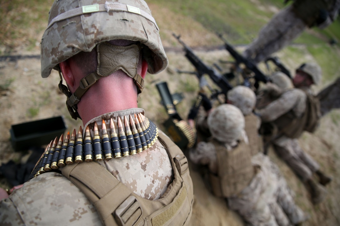 FORT POLK, La. – Machine gunners with 1st Battalion, 23rd Marine Regiment, prepare ammunition during a live-fire range here, June 3. Marines took part in numerous live-fire ranges, which culminated in a platoon-sized attack as a part of the unit’s annual training. The battalion’s machine gunners were responsible for providing suppressing fire for Marines maneuvering to their notional objectives.  (Photo by Cpl. John M. McCall)