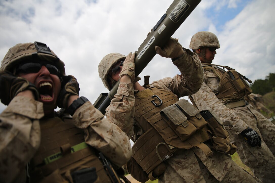 FORT POLK, La. – Corporal Alexander Gil, a section leader with 1st Battalion, 23rd Marine Regiment, and native of Houston, yells out commands to a fellow assualtman during a live-fire range here, June 3. Marines took part in numerous live-fire ranges, which culminated in a platoon-sized attack as a part of the unit’s annual training. The battalion’s assualtmen were responsible for breaching mock enemy obstacles and clearing the way for follow-on forces.  (Photo by Cpl. John M. McCall)