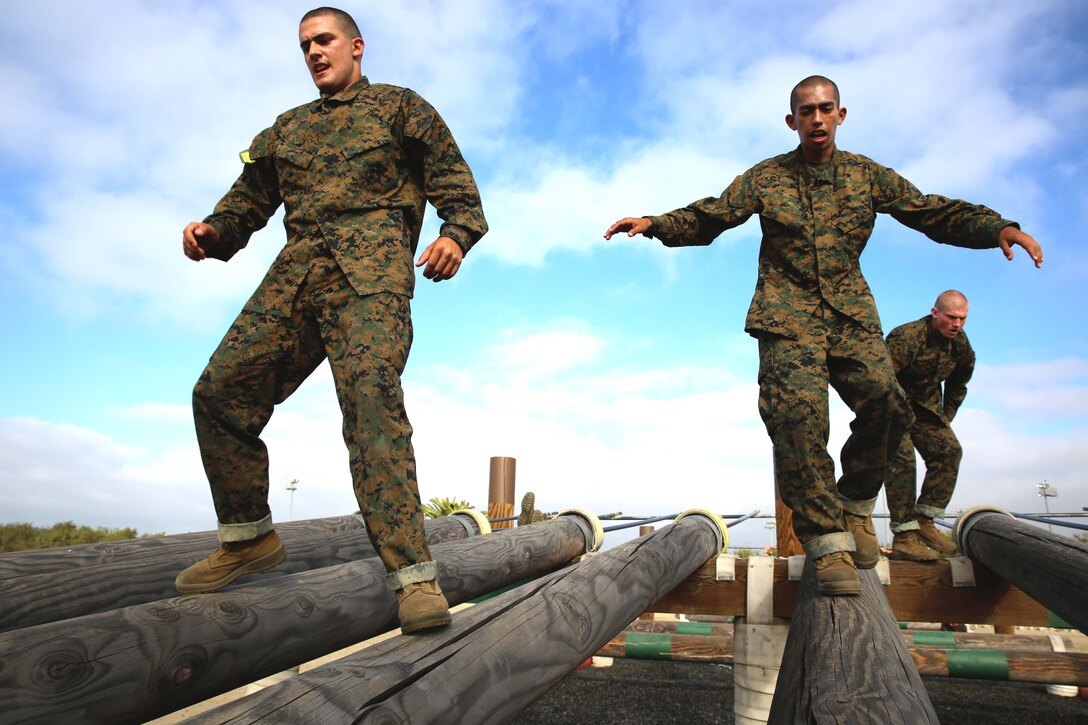 Recruits of Hotel Company, 2nd Recruit Training Battalion, navigate the log challenge in an obstacle course at Marine Corps Recruit Depot San Diego, June 5. Recruits were allowed to use various methods to finish each exercise.