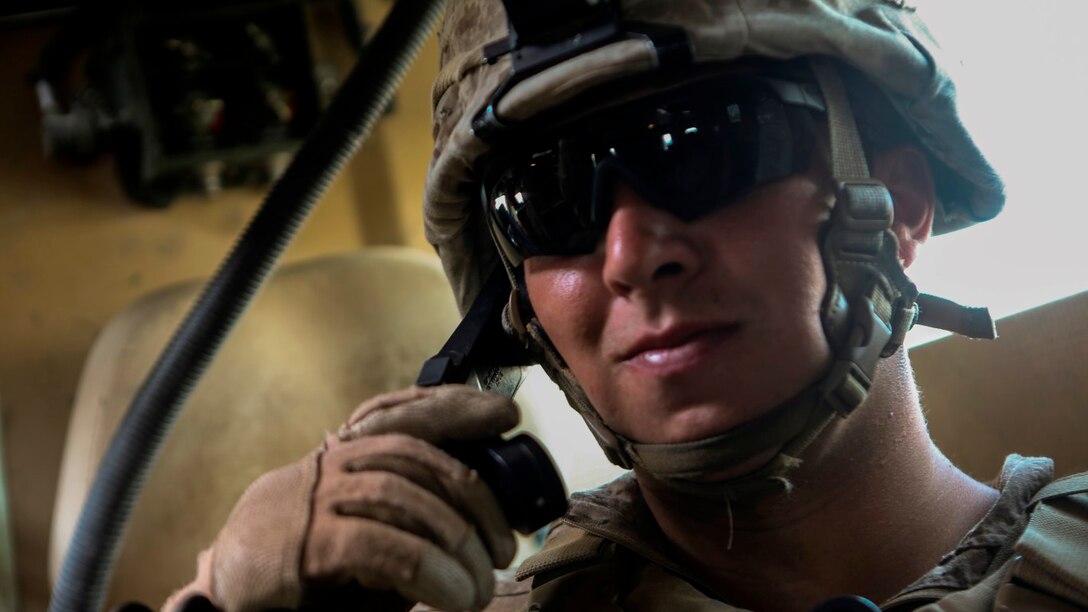 Petty Officer 3rd Class Brock Knowles, a native of Lake Orion, Michigan, goes through several series of radio checks prior to leaving Patrol Base Boldak in Helmand province, Afghanistan, May 15, 2014. Knowles, a corpsman with Charlie Company, 1st Battalion, 2nd Marine Regiment, conducts radio checks to ensure that the Marines and sailors have constant communication while away from the patrol base. (U.S. Marine Corps Photo by Cpl Michael Dye/Released)