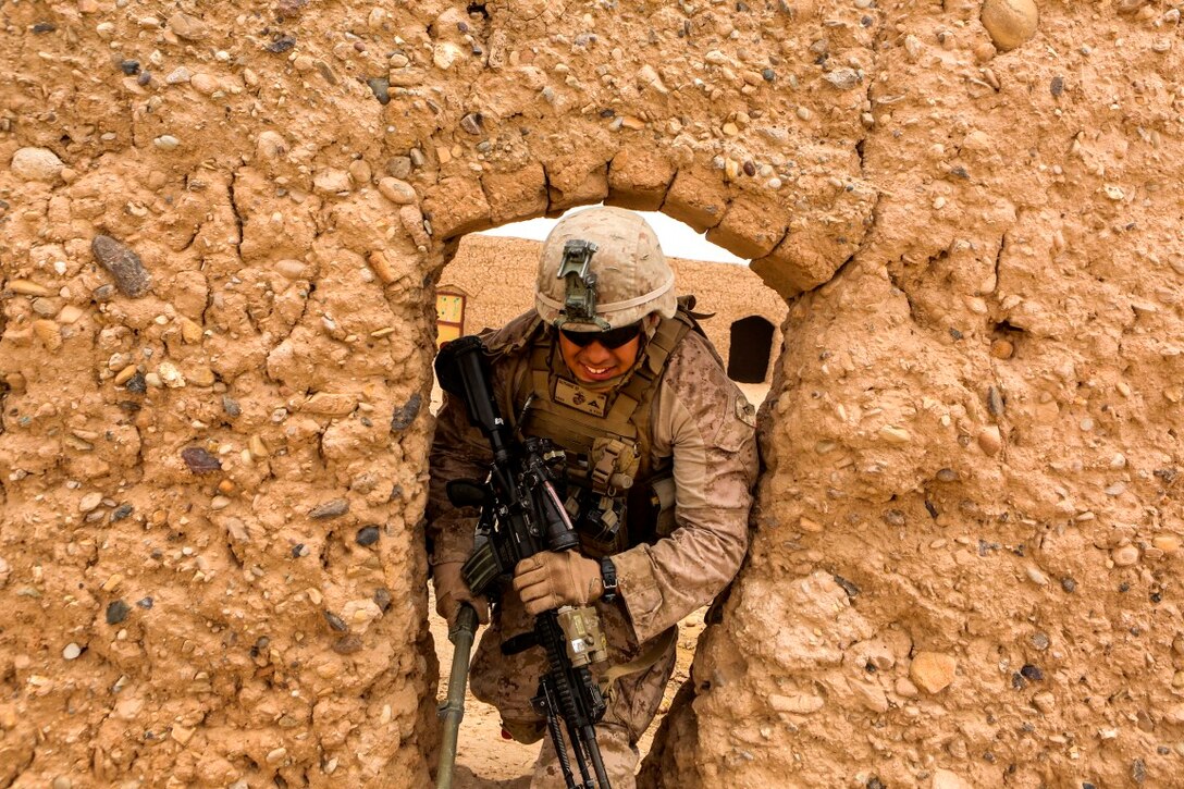 Lance Cpl. Joseph Guthrie III, a native of Jamestown, Pennsylvania, exits an abandoned compound during a reconnaissance patrol near Patrol Base Boldak in Helmand province, Afghanistan, May 15, 2014. Guthrie, a rifleman with Charlie Company, 1st Battalion, 2nd Marine Regiment, and the Marines and sailors of the unit conduct daily patrols in order to maintain trust and communication with the local Afghan population. (U.S. Marine Corps Photo by Cpl Michael Dye/Released)