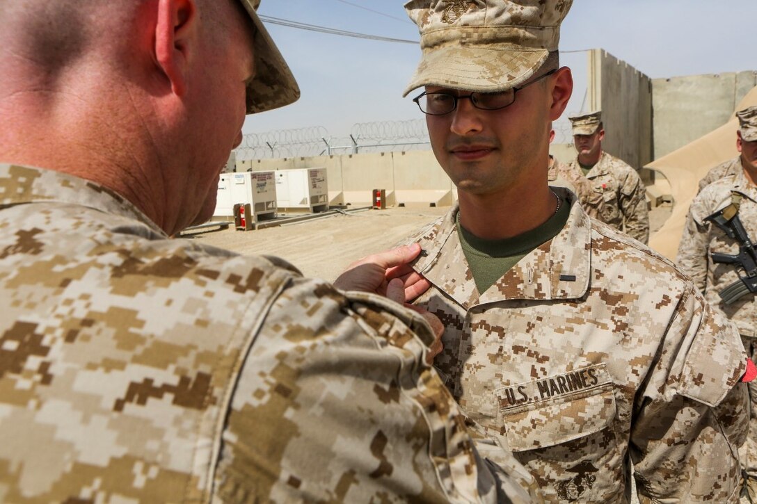 First Lt. Jarred Sabia is promoted by Lt. Col. Bradley Weston, commanding officer, 1st Battalion, 2nd Marine Regiment, during a promotion ceremony aboard Camp Leatherneck, Afghanistan, May 29, 2014. “I joined the Marine Corps for the opportunity to lead Marines, which to me is America’s best fighting force hands down,” said Sabia, a native of Savannah. Sabia is the maintenance management officer with 1st Bn., 2nd Marines. (Marine Corps photo by Cpl. Michael Dye/ Released)
