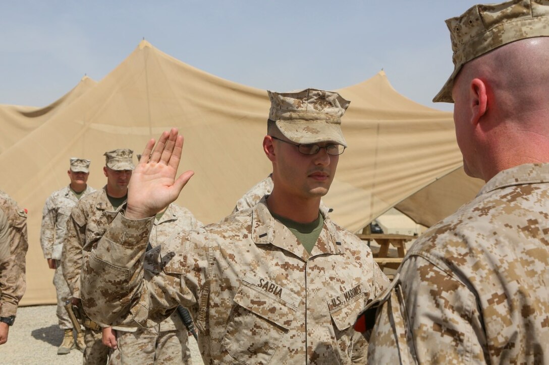 Newly promoted 1st Lt. Jarred Sabia raises his right hand during a promotion ceremony aboard Camp Leatherneck, Afghanistan, May 29, 2014. “I joined the Marine Corps for the opportunity to lead Marines, which to me is America’s best fighting force hands down,” said Sabia, a native of Savannah. Sabia is the maintenance management officer with 1st Bn., 2nd Marines. (Marine Corps photo by Cpl. Michael Dye/ Released)