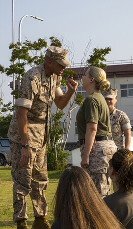 Sgt. Maj. Coleman R. Kinzer corrects at Katherine A. West, Headquarters and Headquarters Squadron Jane Wayne Day participant, for not standing while addressing him aboard Marine Corps Air Station Iwakuni, Japan, May 31, 2014. West is also the family readiness officer for H&HS and coordinator of the event.