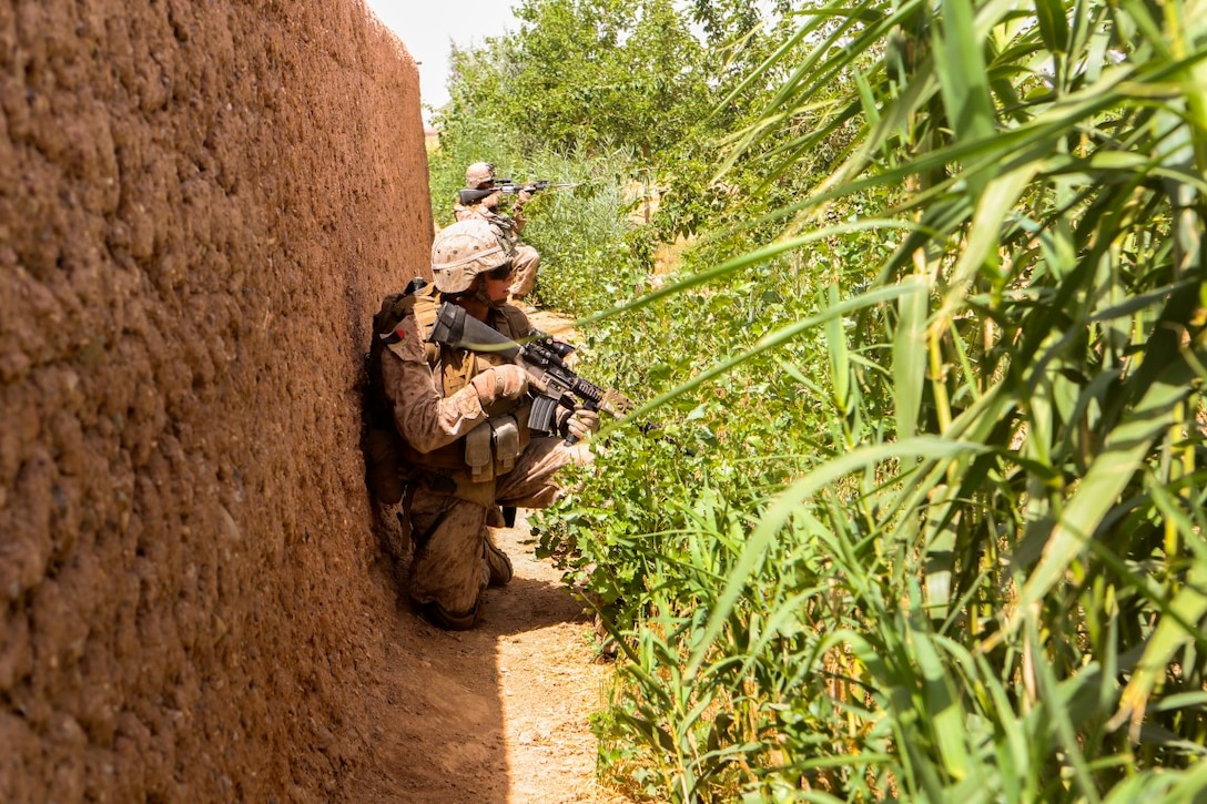 Marines and sailors with Charlie Company, 1st Battalion, 2nd Marine Regiment, move to concealed positions after taking enemy fire during a reconnaissance patrol near Patrol Base Boldak in Helmand Province, Afghanistan, May 15, 2014.  The Marines and sailors of the unit conduct daily patrols in order to maintain trust and communication with the local Afghan population.