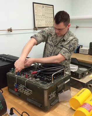 Staff Sgt. Peter Sittinger, 374th Maintenance Squadron precision measurement equipment laboratory technician, unplugs a cord from a pressure tester at Yokota Air Base, Japan. Pressure testers are used on every airframe to determine if the flight sensors are correct. (Courtesy photo/Released)
