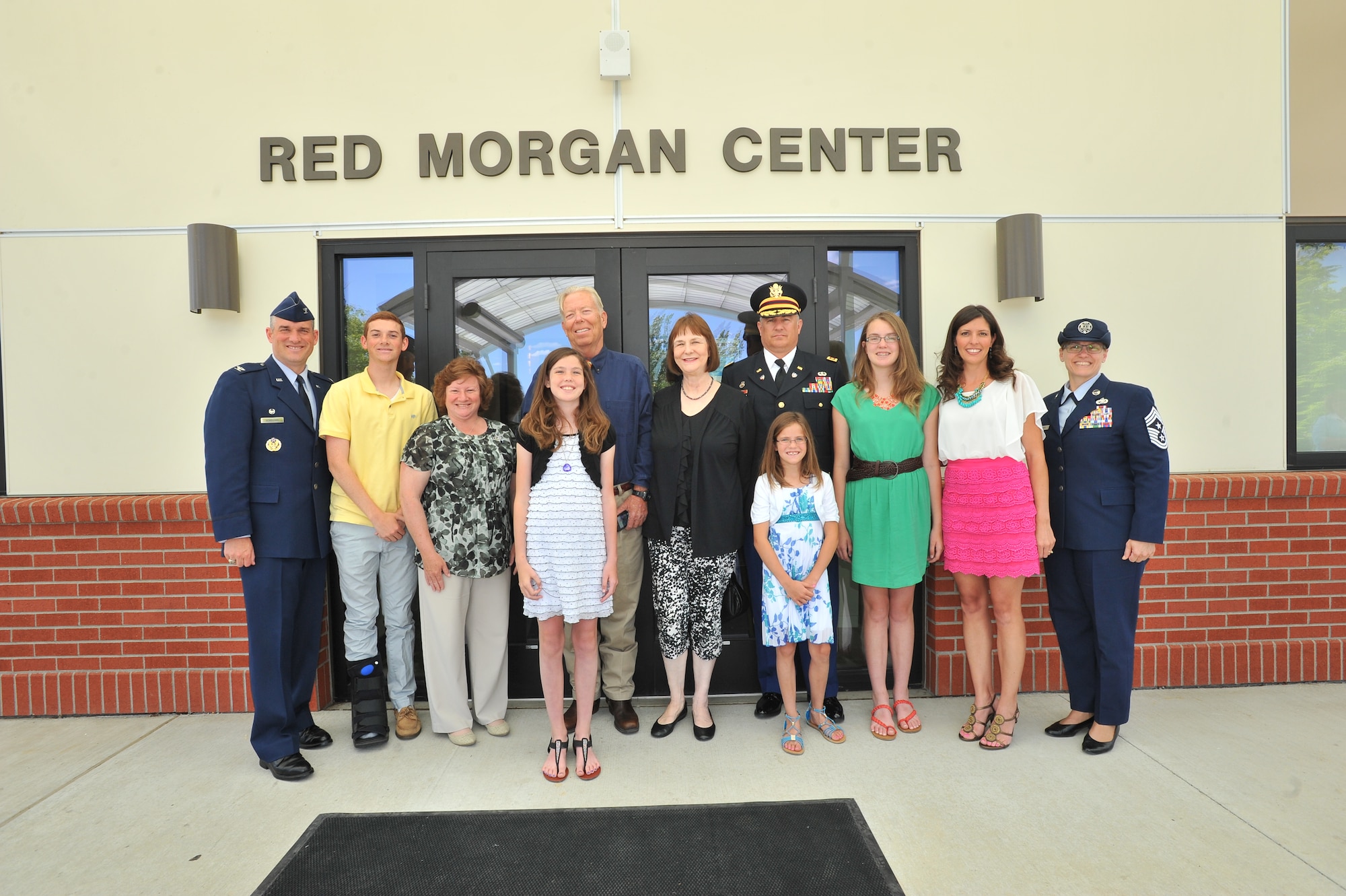 Col. Brian Newberry, 92nd Air Refueling Wing commander, his family, and Chief Master Sgt. Wendy Hansen, 92nd ARW command chief, stand with the family of 2nd Lt. John "Red" Morgan, the 92nd Bombardment Group's only Medal of Honor recipient, June 6, 2014 at Fairchild Air Force Base, Wash., during the dedication ceremony. Morgan was awarded the Medal of Honor for his actions on a bombing mission over Nazi Germany in 1943 while he was a copilot of a B-17 Flying Fortress.  (U.S. Air Force photo by Staff Sgt. Veronica Montes/Released)