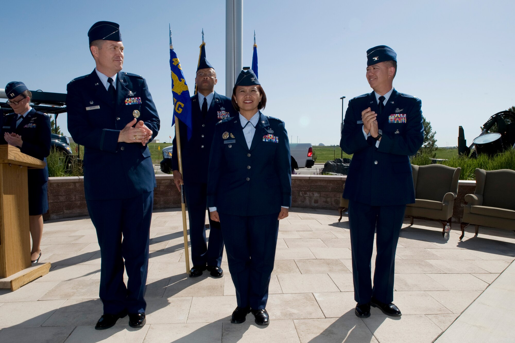 Col. Dan Wright, 460th Space Wing commander, left, and Col. Robert Uemura congratulate Col. Rose Jourdan, 460th Mission Support Group commander, center, for her assumption of command June 10, 2014, at the 460th SW Headquarters on Buckley Air Force Base, Colo. During the ceremony Jourdan assumed command of the 460th MSG from Uemura, who served as the commander since June 2012. (U.S. Air Force photo by Senior Airman Phillip Houk/Released)