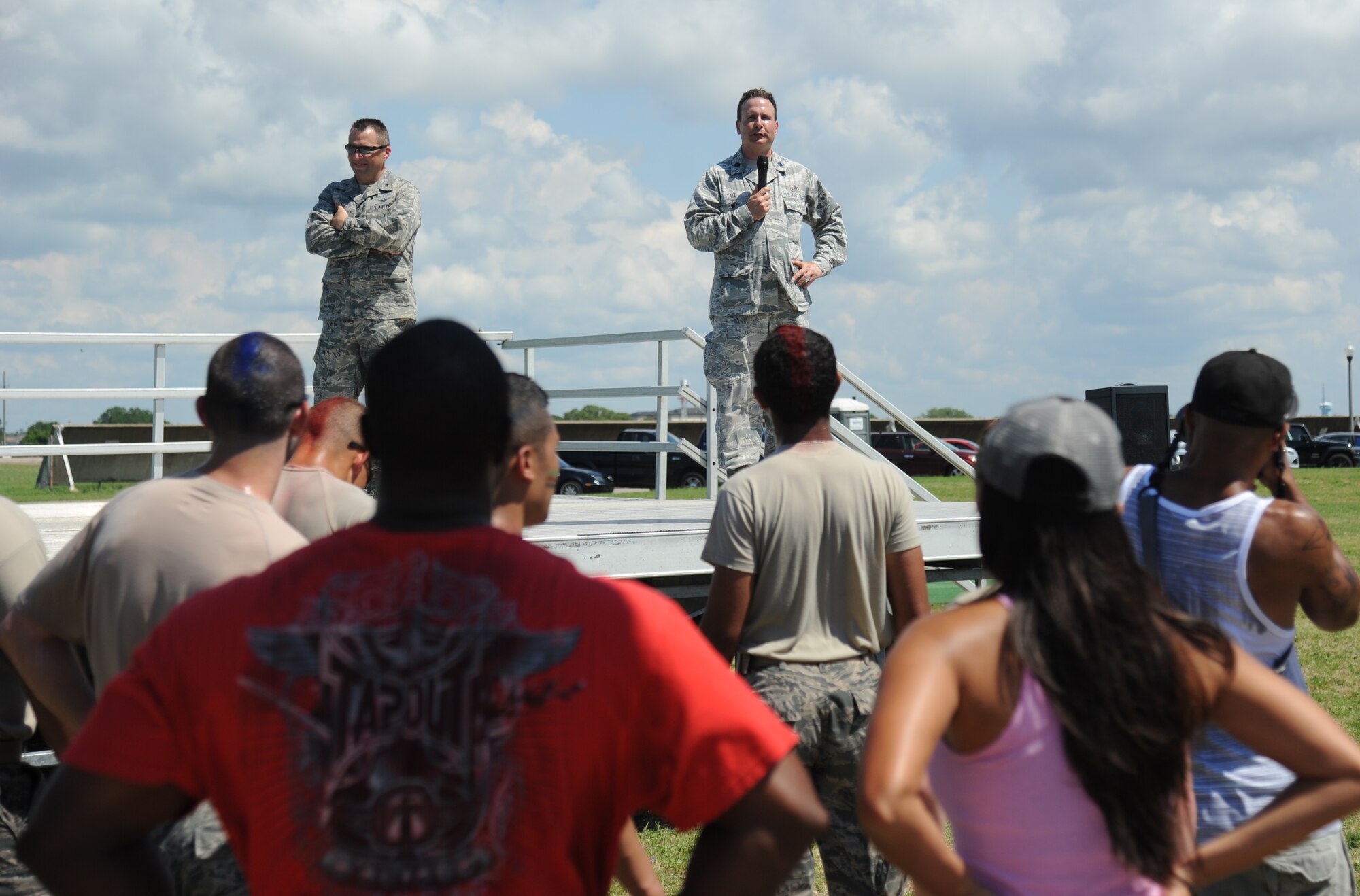 Brig. Gen. Patrick Higby, 81st Training Wing commander, and Lt. Col. Kyle Tate, 81st Mission Support Group deputy commander, make closing remarks following the 81st Training Wing Warrior Challenge hosted by the 81st Mission Support Group June 6, 2014, at the Triangle Track, Keesler Air Force Base, Miss.  The event was held in memory of the 70th anniversary of The Normandy Invasion also known as D-Day.  It consisted of nine six-member teams racing in a competition designed to take them through various aspects of a deployment. (U.S. Air Force photo by Kemberly Groue)