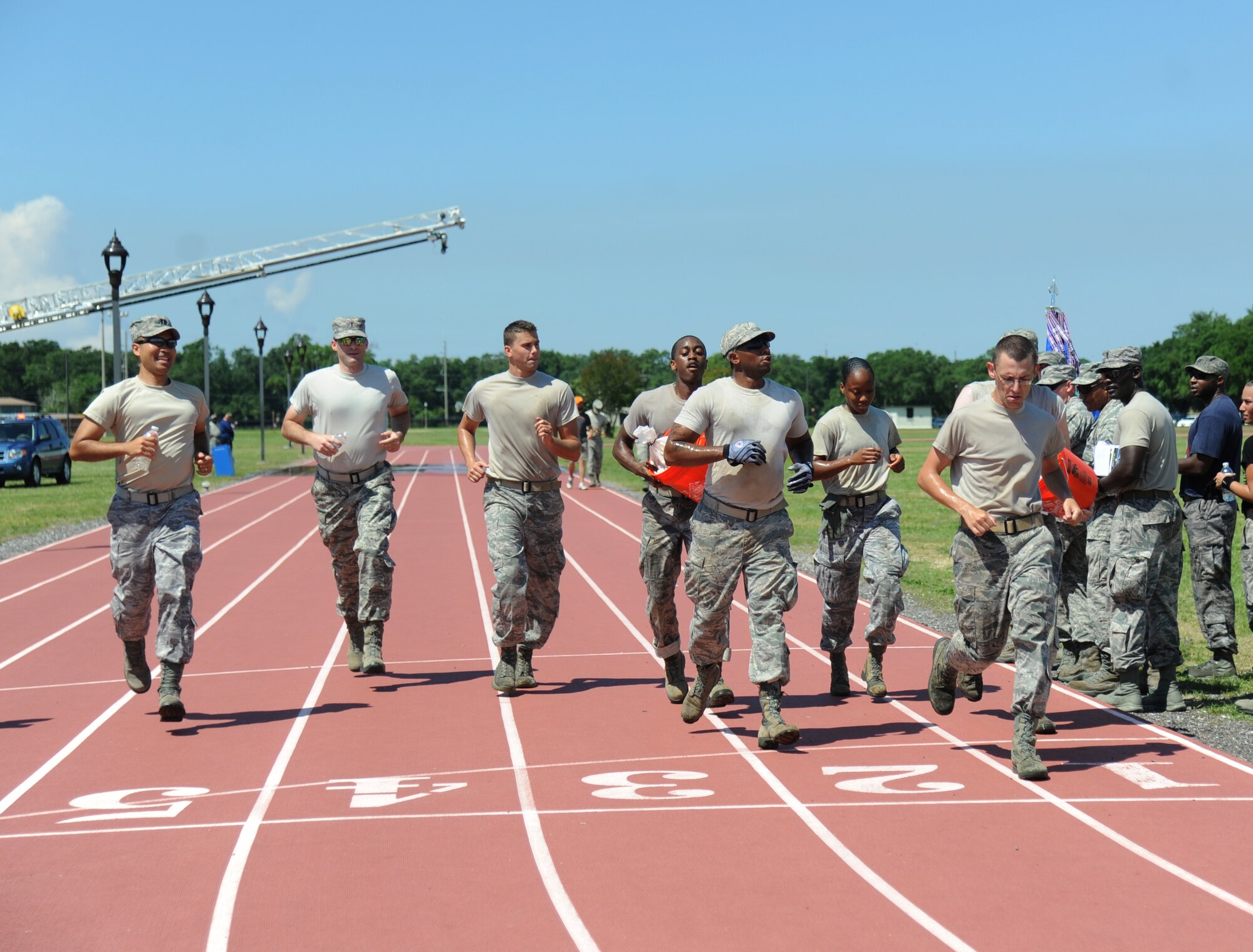 The Gators team closes in on the finish line as they complete, the “Mogadishu Mile,” which is a one-mile run while carrying buckets of sandbags, during the 81st Training Wing Warrior Challenge hosted by the 81st Mission Support Group June 6, 2014, at the Triangle Track, Keesler Air Force Base, Miss.  The challenge was held in memory of the 70th anniversary of The Normandy Invasion also known as D-Day.  It consisted of nine six-member teams racing in a competition designed to take them through various aspects of a deployment. (U.S. Air Force photo by Kemberly Groue)