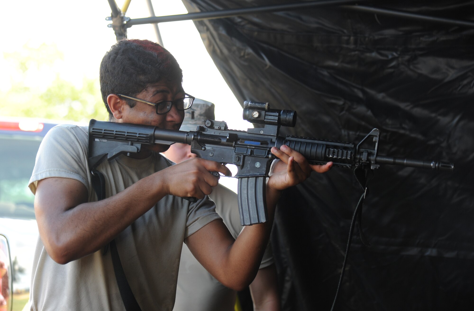 The Logistics Readiness Squadron Warriors team member, Airman 1st Class Cameron Spriggs, fires an M9 weapon at a target in the “Assembled Weapons” challenge during the 81st Training Wing Warrior Challenge hosted by the 81st Mission Support Group June 6, 2014, at the Triangle Track, Keesler Air Force Base, Miss. The event was held in memory of the 70th anniversary of The Normandy Invasion also known as D-Day.  It consisted of nine six-member teams racing in a competition designed to take them through various aspects of a deployment. (U.S. Air Force photo by Kemberly Groue)