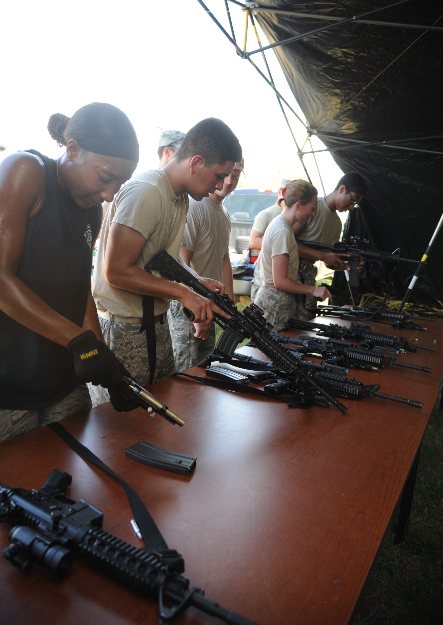 Teams prepare to fire weapons at targets in the “Assembled Weapons” challenge during the 81st Training Wing Warrior Challenge hosted by the 81st Mission Support Group June 6, 2014, at the Triangle Track, Keesler Air Force Base, Miss. The event was held in memory of the 70th anniversary of The Normandy Invasion also known as D-Day.  It consisted of nine six-member teams racing in a competition designed to take them through various aspects of a deployment. (U.S. Air Force photo by Kemberly Groue)