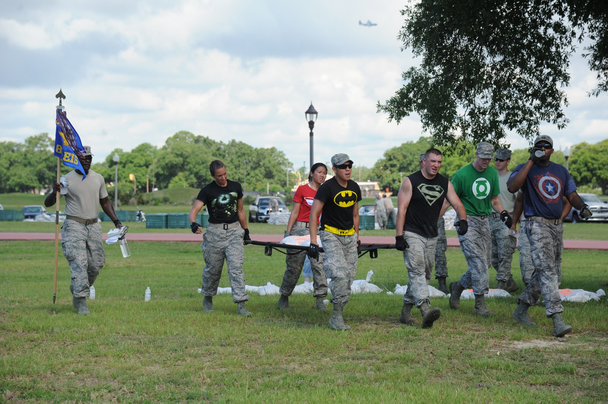 The Justice League team from the 85th Engineering Installation Squadron work together in the “Litter Carry” challenge during the 81st Training Wing Warrior Challenge hosted by the 81st Mission Support Group June 6, 2014, at the Triangle Track, Keesler Air Force Base, Miss.  The challenge consists of team members carrying a litter of sandbags through cones to the designated location.  The challenge was held in memory of the 70th anniversary of The Normandy Invasion also known as D-Day.  It consisted of nine six-member teams racing in a competition designed to take them through various aspects of a deployment. (U.S. Air Force photo by Kemberly Groue)