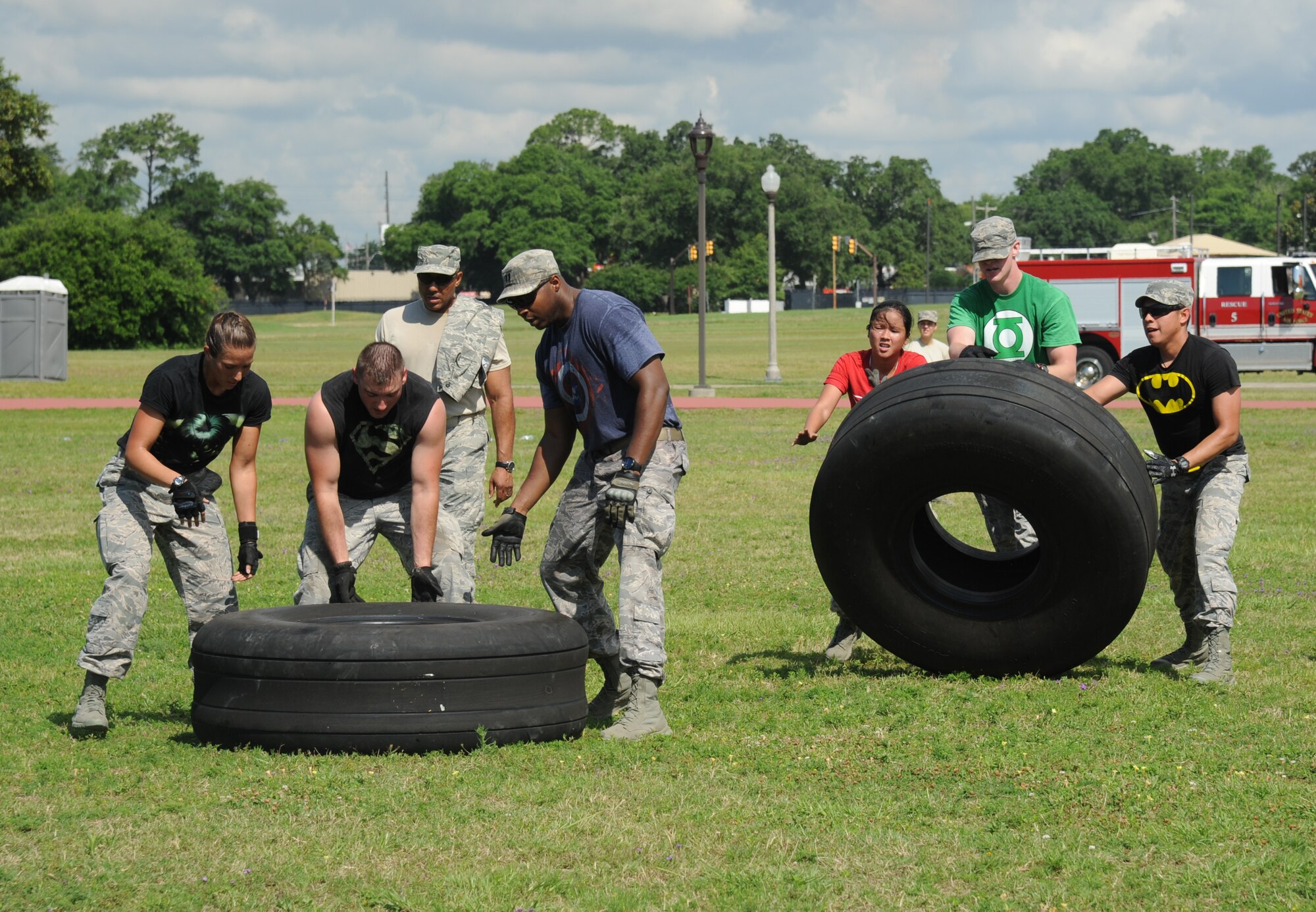 The Justice League team from the 85th Engineering Installation Squadron work together in the “Tire Flipping” challenge during the 81st Training Wing Warrior Challenge hosted by the 81st Mission Support Group June 6, 2014, at the Triangle Track, Keesler Air Force Base, Miss.  The challenge consists of personnel flipping an aircraft tire to the designated location.  The challenge was held in memory of the 70th anniversary of The Normandy Invasion also known as D-Day.  It consisted of nine six-member teams racing in a competition designed to take them through various aspects of a deployment. (U.S. Air Force photo by Kemberly Groue)