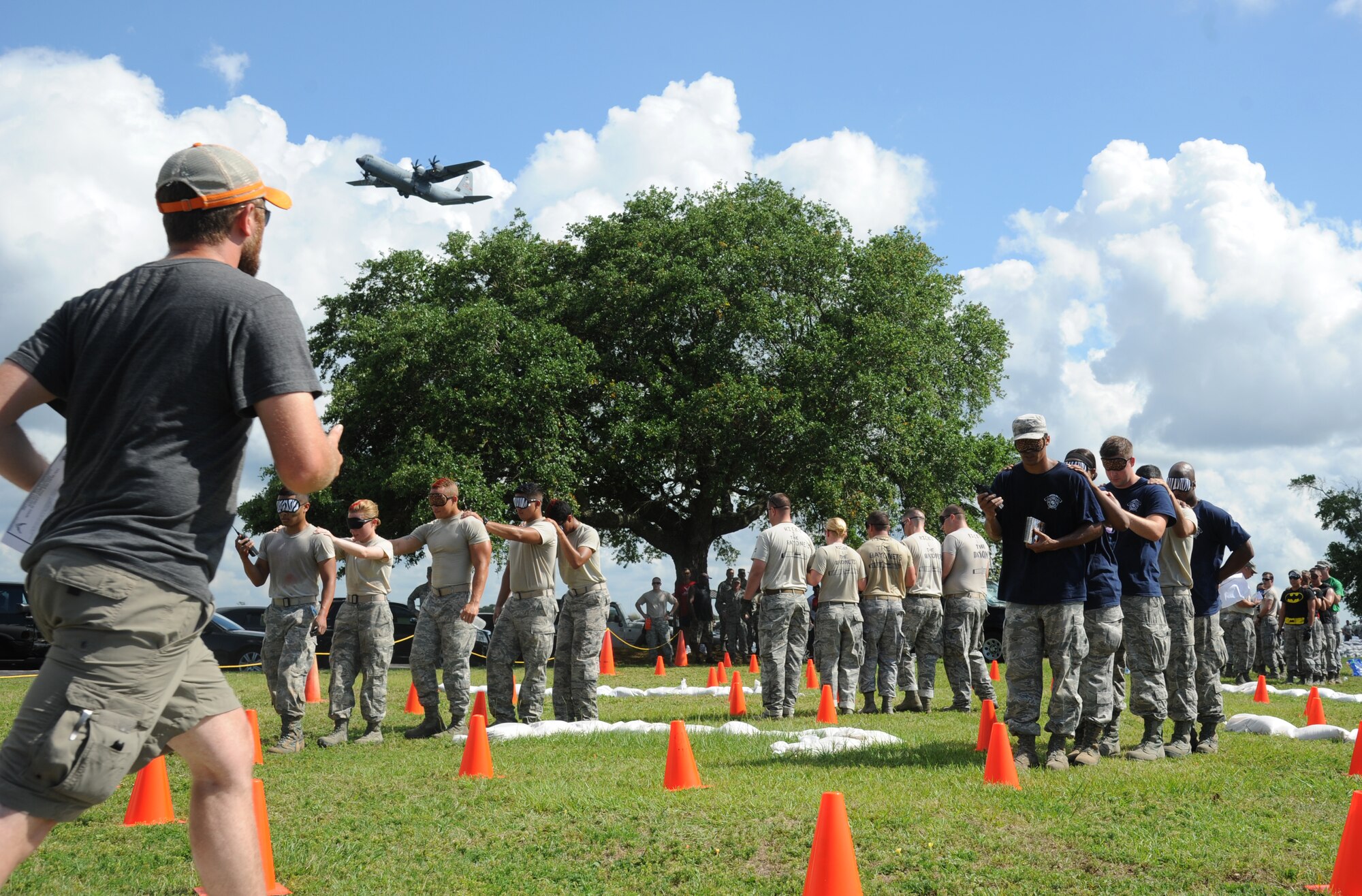 Teams compete in the “Communications” challenge during the 81st Training Wing Warrior Challenge hosted by the 81st Mission Support Group June 6, 2014, at the Triangle Track, Keesler Air Force Base, Miss.  The challenge consisted of one team member leading the rest of the team through a blindfolded course via handheld radio.  The Warrior Challenge event was held in memory of the 70th anniversary of The Normandy Invasion also known as D-Day.  (U.S. Air Force photo by Kemberly Groue)