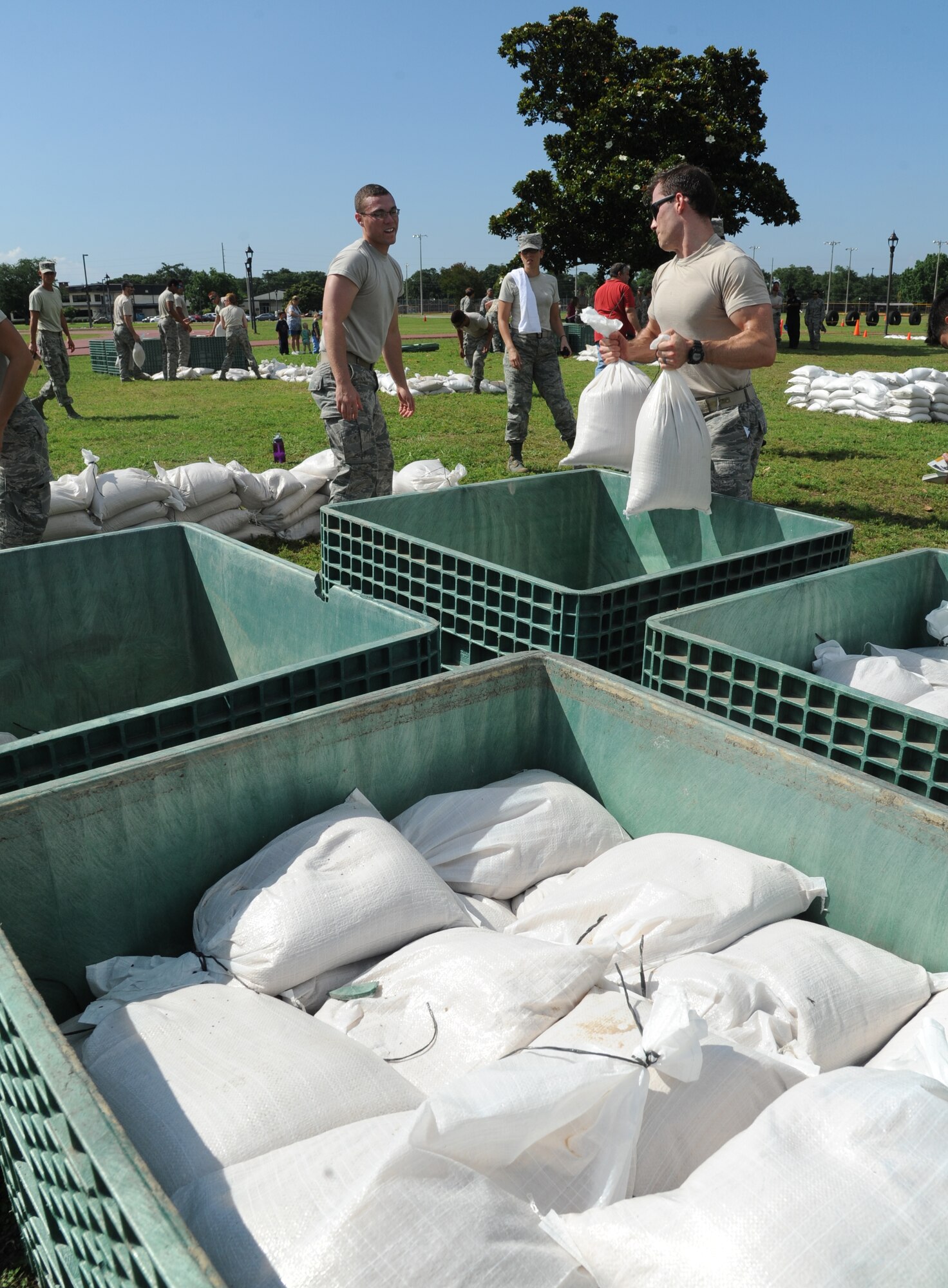 The Medics team members, Senior Airmen Zachary Bartlett and Robert Desantis, from the 81st Medical Group, transport sandbags to make a defensive wall in the “Sandbag Stacking” challenge during the 81st Training Wing Warrior Challenge hosted by the 81st Mission Support Group June 6, 2014, at the Triangle Track, Keesler Air Force Base, Miss.  The event was held in memory of the 70th anniversary of The Normandy Invasion also known as D-Day.  It consisted of nine six-member teams racing in a competition designed to take them through various aspects of a deployment. (U.S. Air Force photo by Kemberly Groue)