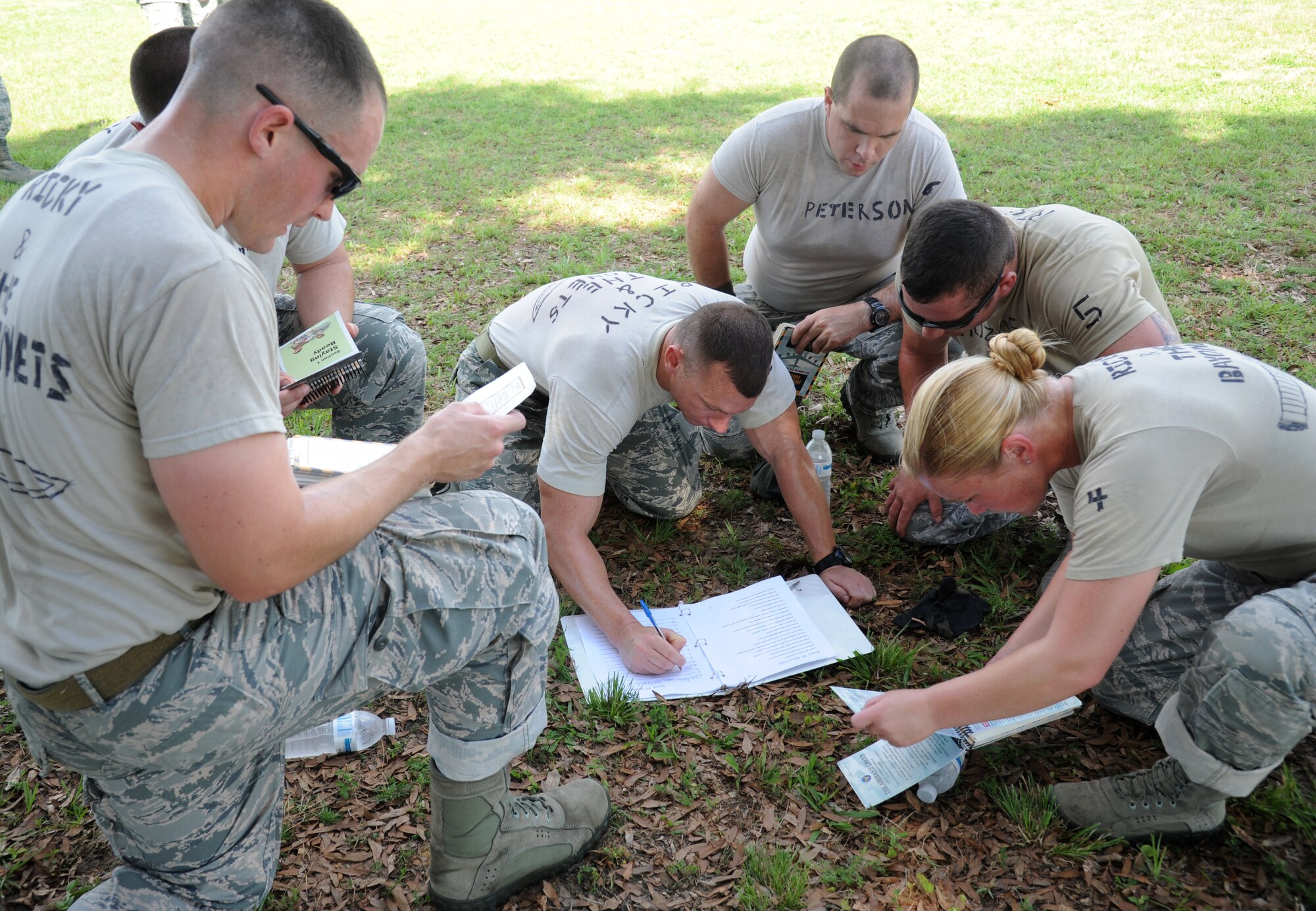 Ricky & The Bayonets team members from the 81st Security Forces Squadron competes in the “20 question quiz” challenge during the 81st Training Wing Warrior Challenge hosted by the 81st Mission Support Group June 6, 2014, at the Triangle Track, Keesler Air Force Base, Miss.  The challenge consists of answering 20 questions about the Air Force to demonstrate readiness to deploy. The Warrior Challenge event consisted of nine six-member teams racing in a competition designed to take them through various aspects of a deployment. Ricky & The Bayonets placed first in the competition. (U.S. Air Force photo by Kemberly Groue)