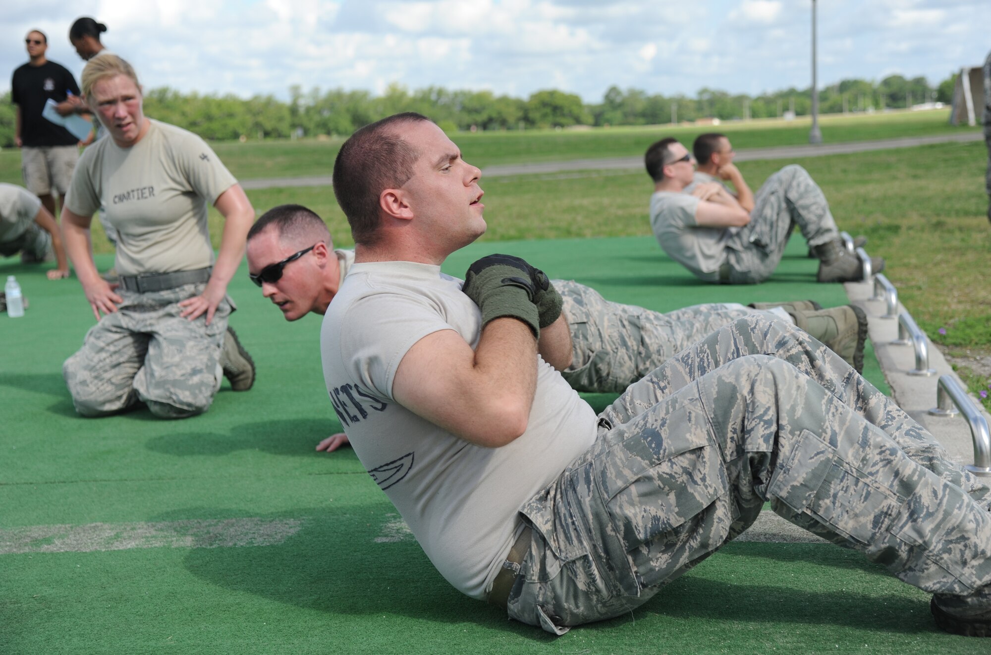 Ricky & The Bayonets team member, Senior Airman Jesse Peterson, from the 81st Security Forces Squadron competes in the first challenge “Pushups and Situps” challenge during the 81st Training Wing Warrior Challenge hosted by the 81st Mission Support Group June 6, 2014, at the Triangle Track, Keesler Air Force Base, Miss.  The challenge consists of completing 600 pushups and situps by all team members. The challenge was held in memory of the 70th anniversary of The Normandy Invasion also known as D-Day.  It consisted of nine six-member teams racing in a competition designed to take them through various aspects of a deployment. Ricky & The Bayonets placed first in the competition. (U.S. Air Force photo by Kemberly Groue)