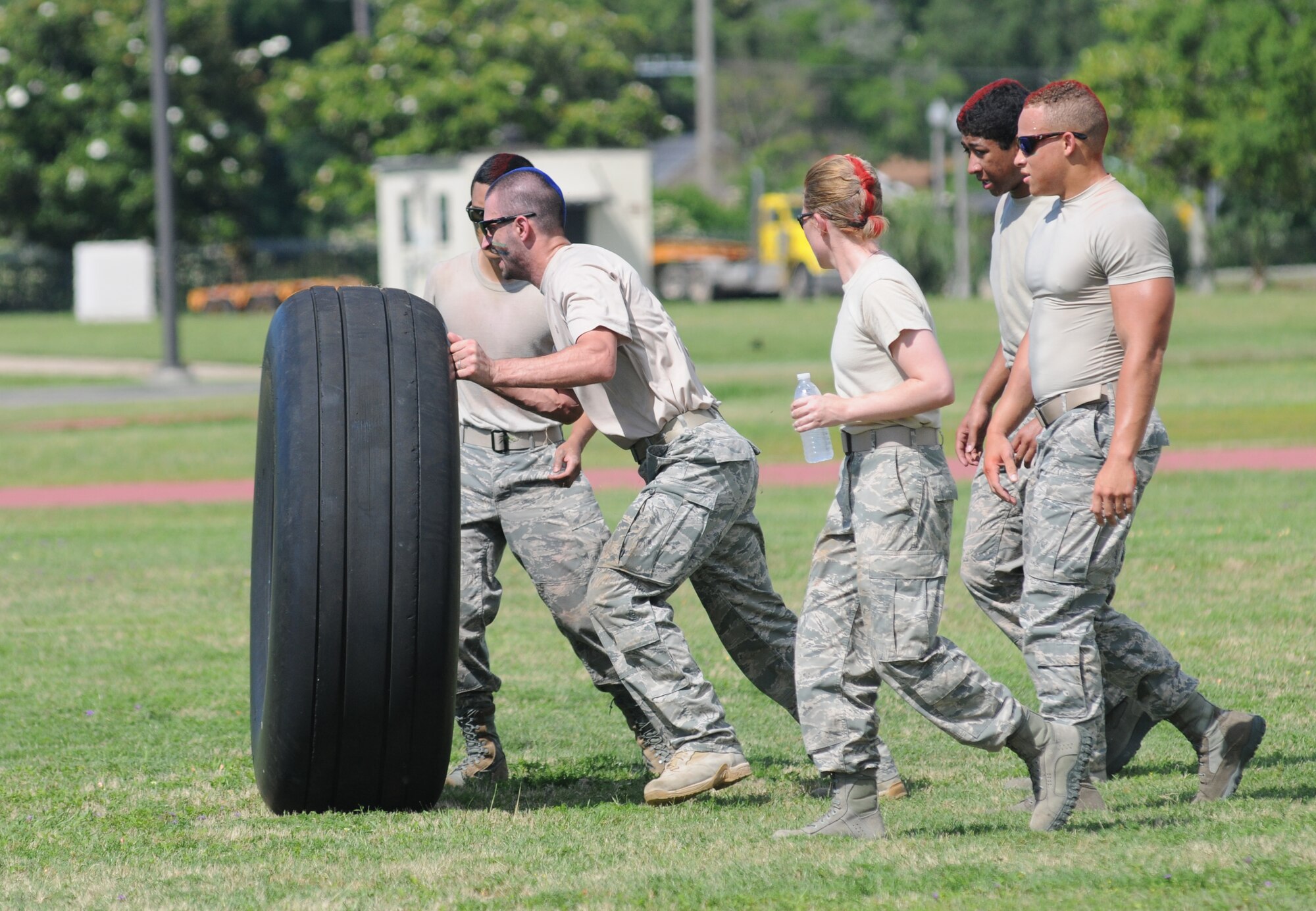 The Logistics Readiness Squadron Warriors team compete in the “Tire Flipping” challenge during the 81st Training Wing Warrior Challenge hosted by the 81st Mission Support Group June 6, 2014, at the Triangle Track, Keesler Air Force Base, Miss.  The challenge consists of personnel flipping an aircraft tire to the designated location.  The Warrior Challenge was held in memory of the 70th anniversary of The Normandy Invasion also known as D-Day.  (U.S. Air Force photo by Kemberly Groue)
