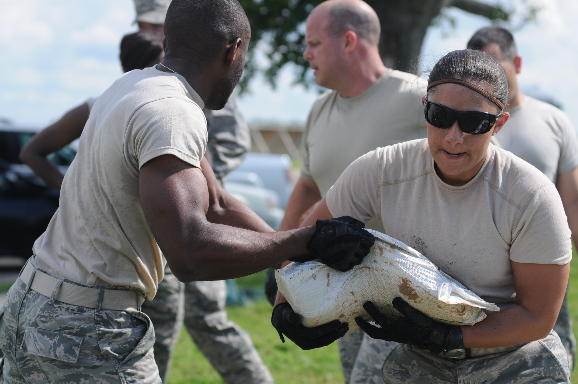 The Finishers team members from the Wing Staff Agencies, Airman 1st Class Chigozie Nwachuku, 81st Comptroller Squadron, and Tech. Sgt. Carleen Wallace, 81st Training Wing, transport sandbags to make a defensive wall in the “Sandbag Stacking” challenge during the 81st Training Wing Warrior Challenge hosted by the 81st Mission Support Group June 6, 2014, at the Triangle Track, Keesler Air Force Base, Miss.  The event was held in memory of the 70th anniversary of The Normandy Invasion also known as D-Day.  It consisted of nine six-member teams racing in a competition designed to take them through various aspects of a deployment. (U.S. Air Force photo by Kemberly Groue)
