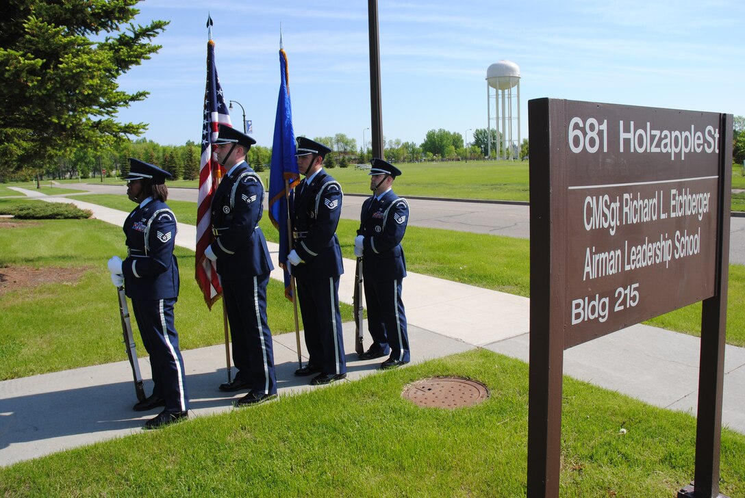 Members of the Grand Forks Air Force Base Honor Guard stoically stand by for the start of the ceremony where the airman leadership school on Grand Forks Air Force base, N.D., was named after Chief Master Sgt. Richard L. Etchberger, June 4, 2014.  Each of the Honor Guard members presenting the colors this day graduated from the Chief Etchberger ALS. (U.S. Air Force photo/Staff Sgt. Luis Loza Gutierrez) 