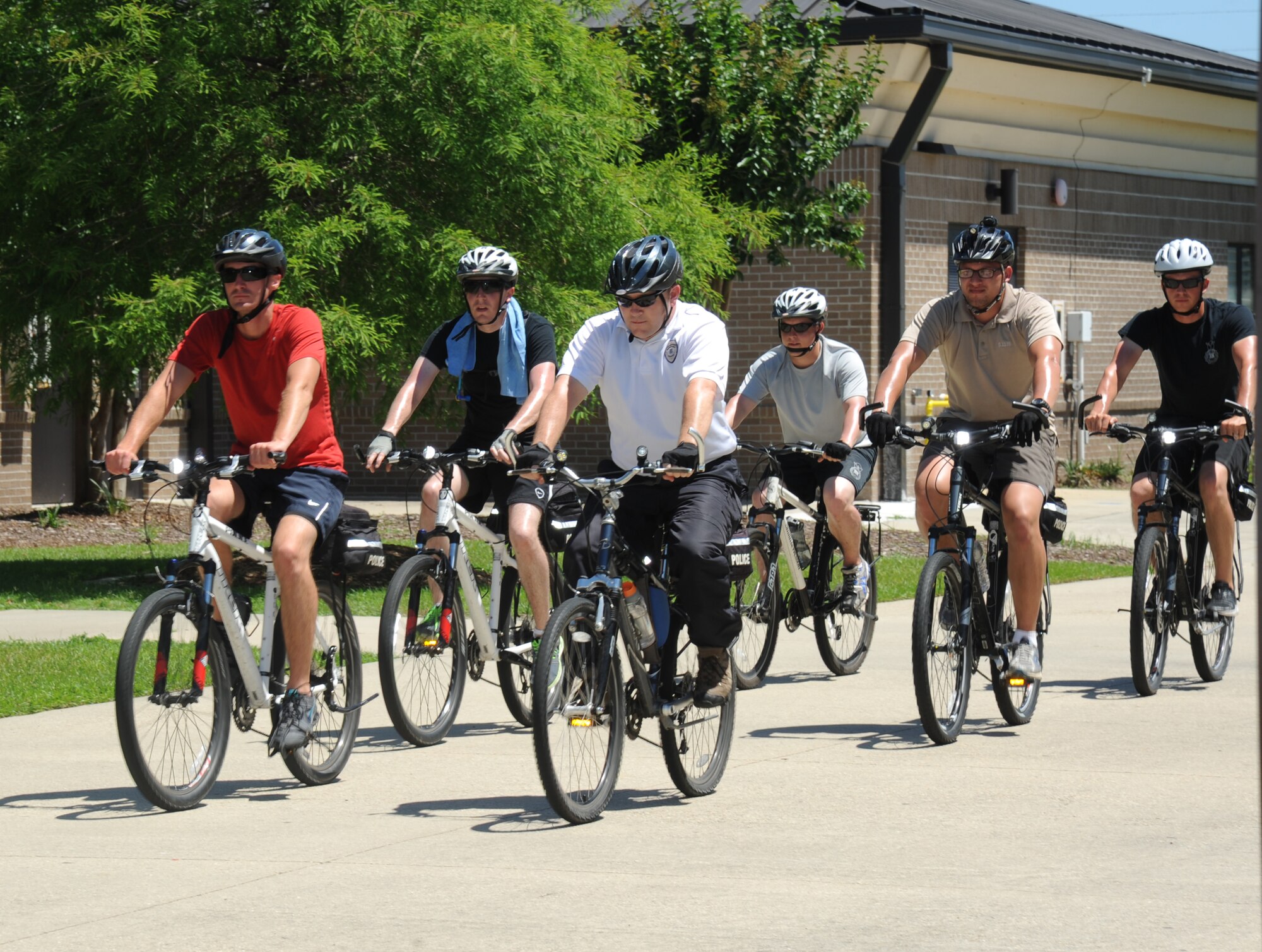 Warren Breckinridge, 81st Security Forces Squadron unit trainer, (in white shirt), rides along with members of the 81st SFS Airmen as they continue a 100-mile bike ride, which takes place over a course of five days June 4, 2014, in the triangle at Keesler Air Force Base, Miss.  The 81st SFS held a five-day bicycle training class June 2-6, 2014, for Keesler law enforcement Airmen which consists of bike safety, road hazards, proper stopping, use of bike as a defense mechanism, and dismounts at high speed as well as a total bike ride of over 100 miles. Bike patrols are a stealthy and versatile option for security forces officers, which can be used for special events, community policing, and crime prevention.  (U.S. Air Force photo by Kemberly Groue)