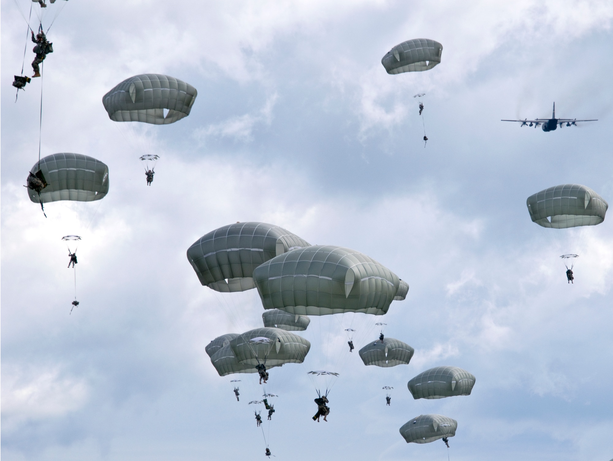 Paratroopers with the 4th Infantry Brigade Combat Team (Airborne), 25th Infantry Division jump from an Alaska Air National Guard C-130 Hercules on Joint Base Elmendorf-Richardson, Alaska, as part of a Joint Force Entry Exercise on June 7, 2014. The six-day exercise involved over 1,500 personnel including active duty Army, Air Force and Air National Guard. (U.S. Air National Guard Photo by Capt. John Callahan/ Released)