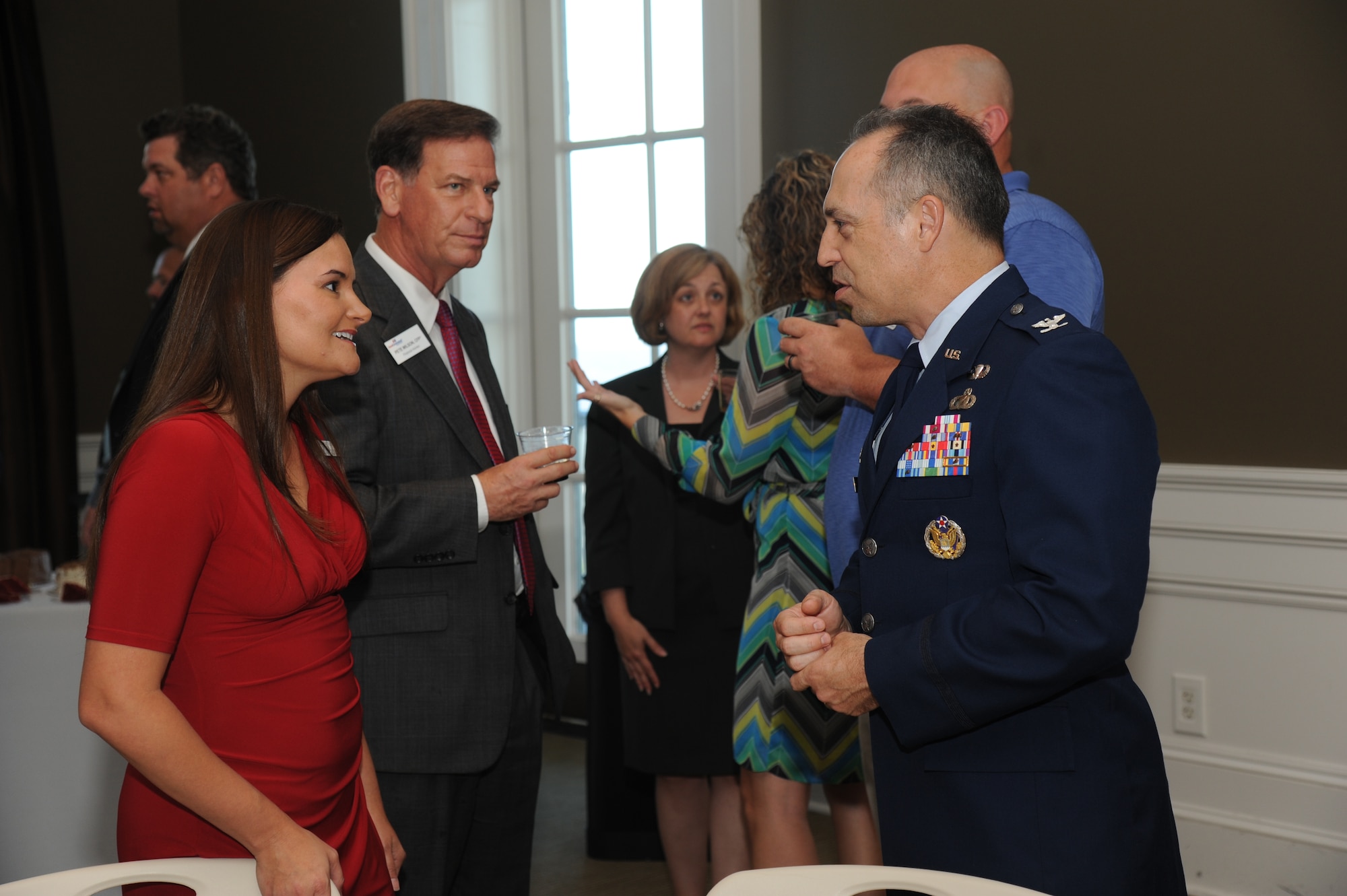 Jessica Bartels, Keesler Federal Credit Union business education specialist, speaks with Col. George Tombe, IV, 81st Training Group commander, Keesler Air Force Base, Miss., during the Biloxi Chamber of Commerce flag sponsor appreciation reception June 4, 2014, at the Biloxi visitors center. Keesler Federal was one of many sponsors who donated funds to support the base with purchasing two sets of the 50 state flags and six territory flags that hang on display as you enter the base on Larcher Blvd.  (U.S. Air Force photo by Kemberly Groue)