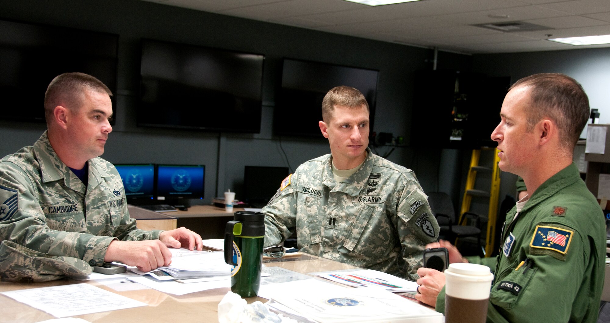 Members from the 773rd Logistics Readiness Group; 4th Brigade Combat Team (Airborne), 25th Infantry Division; and the 176th Operations Group coordinate mission planning on Joint Base Elmendorf-Richardson, Alaska, June 6, 2014. Alaska guardsmen and active duty soldiers and airmen combined efforts during a six-day Joint Forcible Entry Exercise. (U.S. Air National Guard photo by Staff Sgt. N. Alicia Halla. Released)
