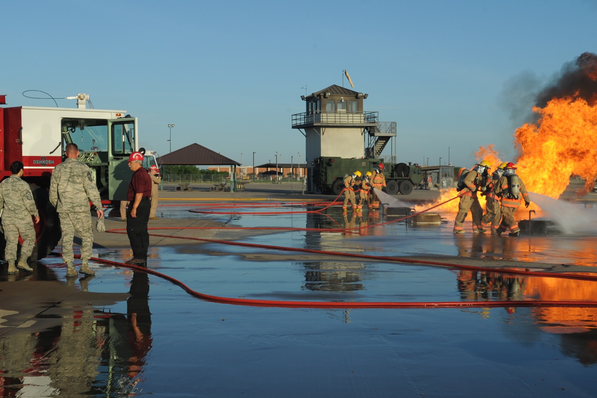 GOODFELLOW AIR FORCE BASE, Texas -- Chief Master Sgt. Arleen K. Heath, Air Force Intelligence, Surveillance and Reconnaissance Command Chief, left, walks to the fire truck on the Louis F. Garland Department of Defense Fire Academy training pad here June 3. Heath toured several locations throughout the day beginning with the Louis F. Garland Department of Defense Fire Academy and ending with a visit to the Crossroads Student Center. (U.S. Air Force photo/ Staff Sgt. Laura R. McFarlane)