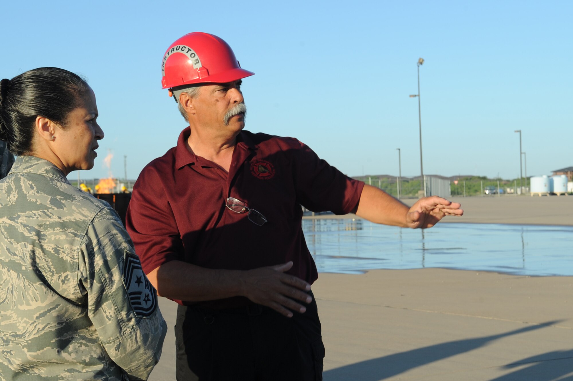 GOODFELLOW AIR FORCE BASE, Texas -- Rodney G. Born, 312th Training Squadron and Louis F. Garland Department of Defense Fire Academy Airport Firefighter block supervisor, shows Chief Master Sgt. Arleen K. Heath, Air Force Intelligence, Surveillance and Reconnaissance Command Chief, the fire academy training pad here June 3. This was Heath’s first visit to the fire academy. (U.S. Air Force photo/ Staff Sgt. Laura R. McFarlane)