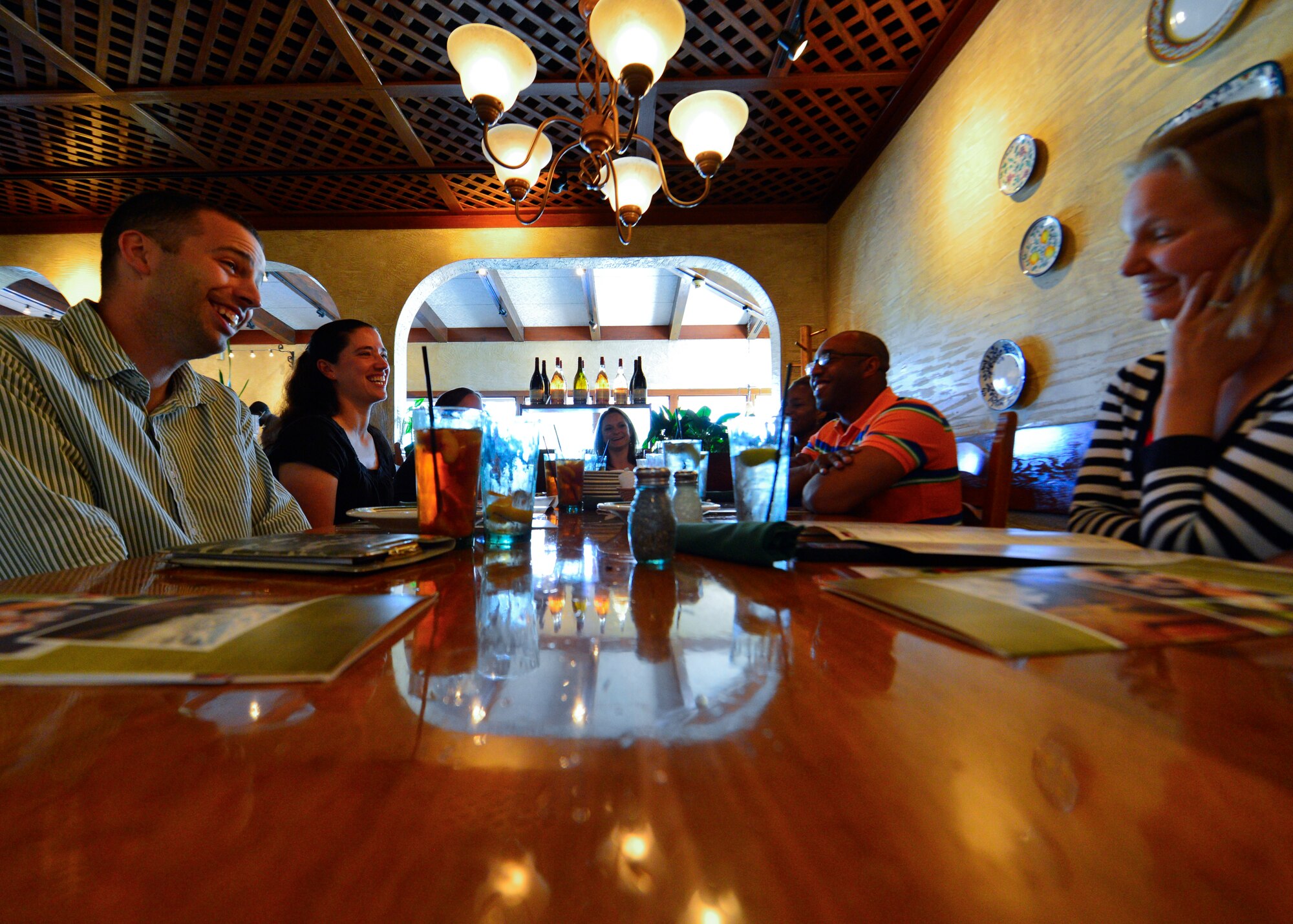 Chaplain (Capt) Joshua Rumsey, 436th Airlift Wing chaplain, laughs with his wife, Kati Rumsey, at a  single parents appreciation dinner June 6, 2014, at Olive Garden in Dover, Del. Rumsey and Staff Sgt. Javon Merritte, 436th AW chaplain assistant, far right, hosted a free dinner and taught parents about financial and time management. (U.S. Air Force photo/Airman 1st Class William Johnson)